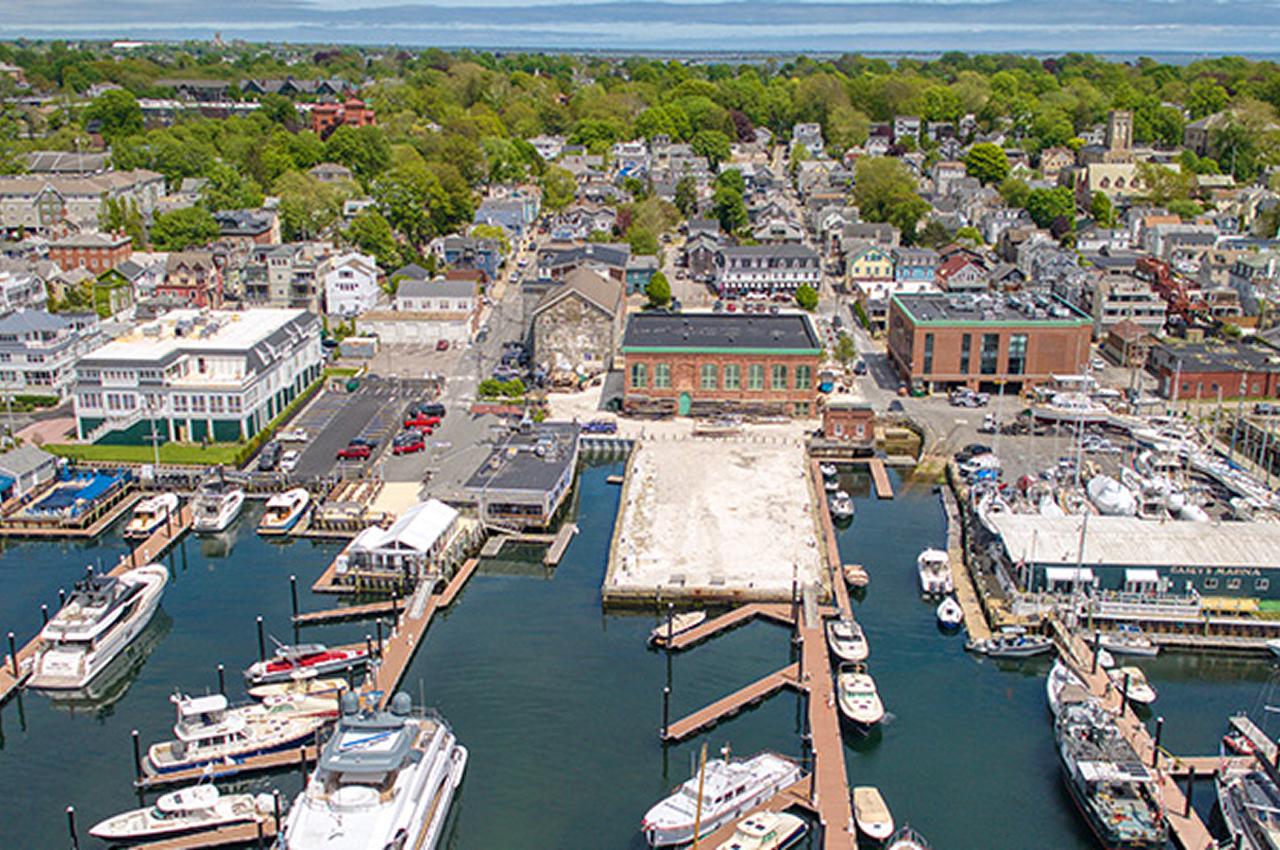Aerial view of a waterfront town with boats and docks.